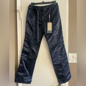 super stylish. size on tag 38 euro. waits measures 27”. inseam 29” 100% nylon.